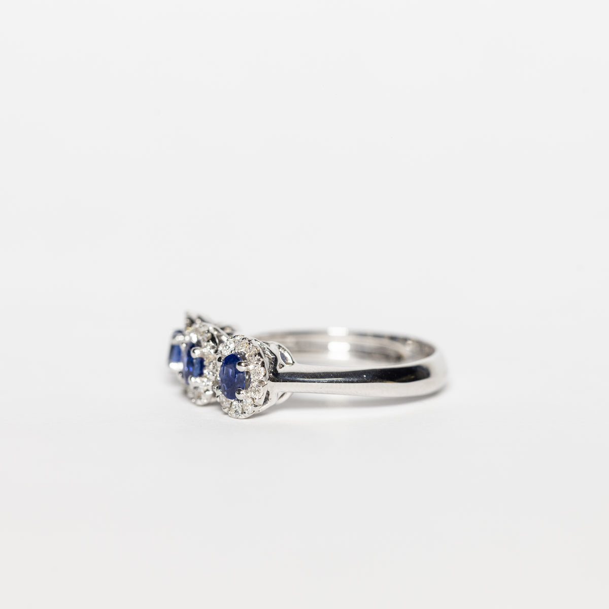 White Gold Trilogy Ring With Sapphires Surrounded By Diamonds