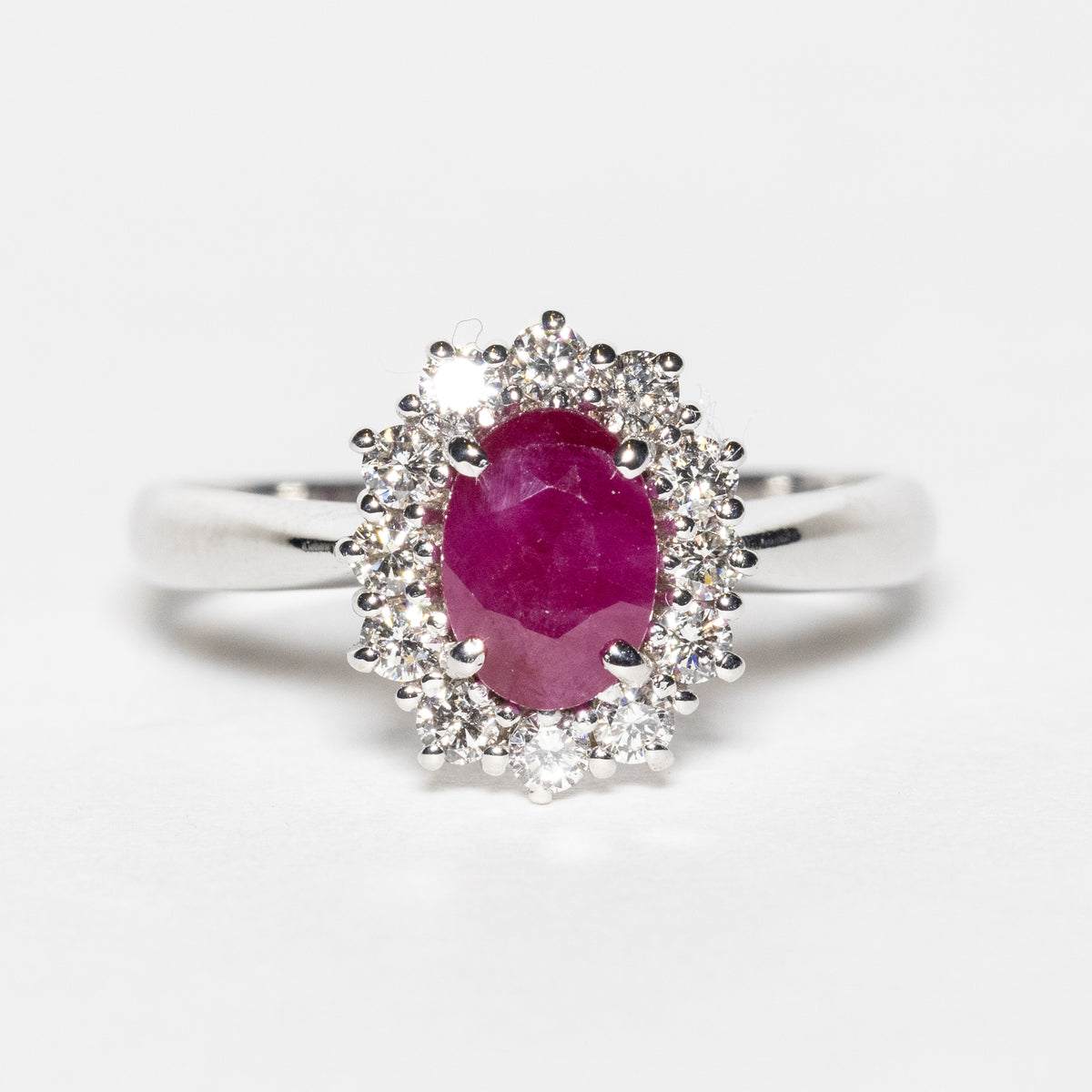 18KT White Gold Ring with Oval Central Ruby and Diamond Surround