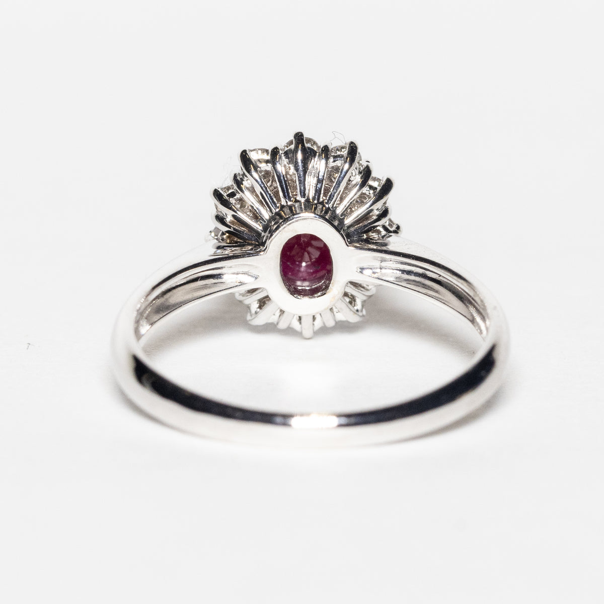 18KT White Gold Ring with Oval Central Ruby and Diamond Surround