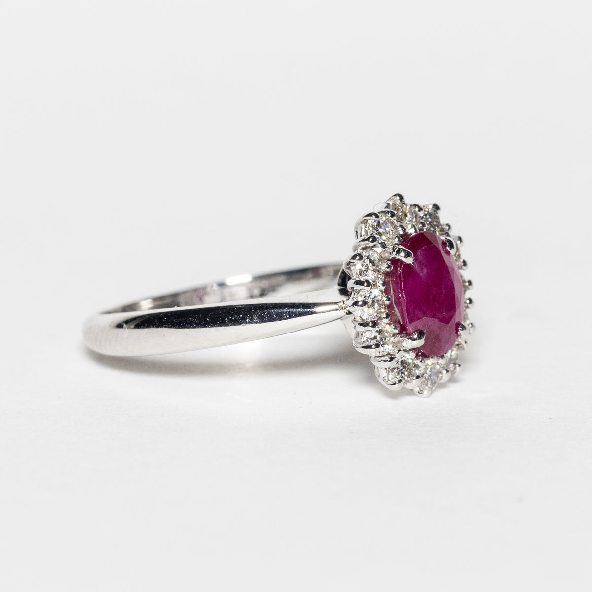 18KT White Gold Ring with Oval Central Ruby and Diamond Surround