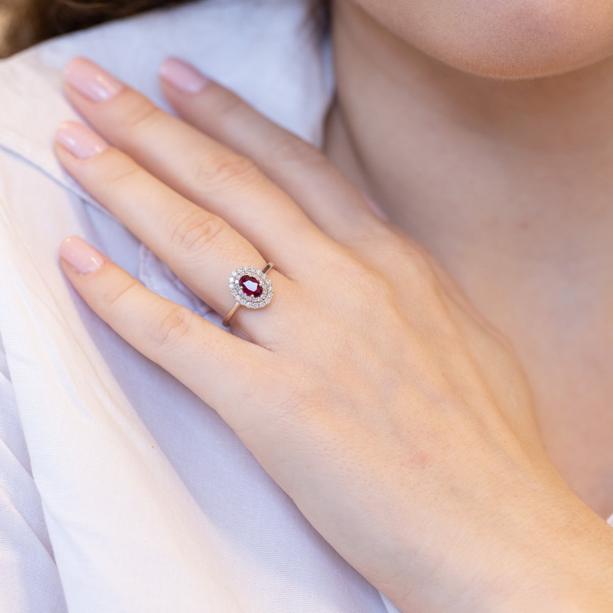 18KT White Gold Ring with Oval-Shaped Ruby and Double Diamond Surround