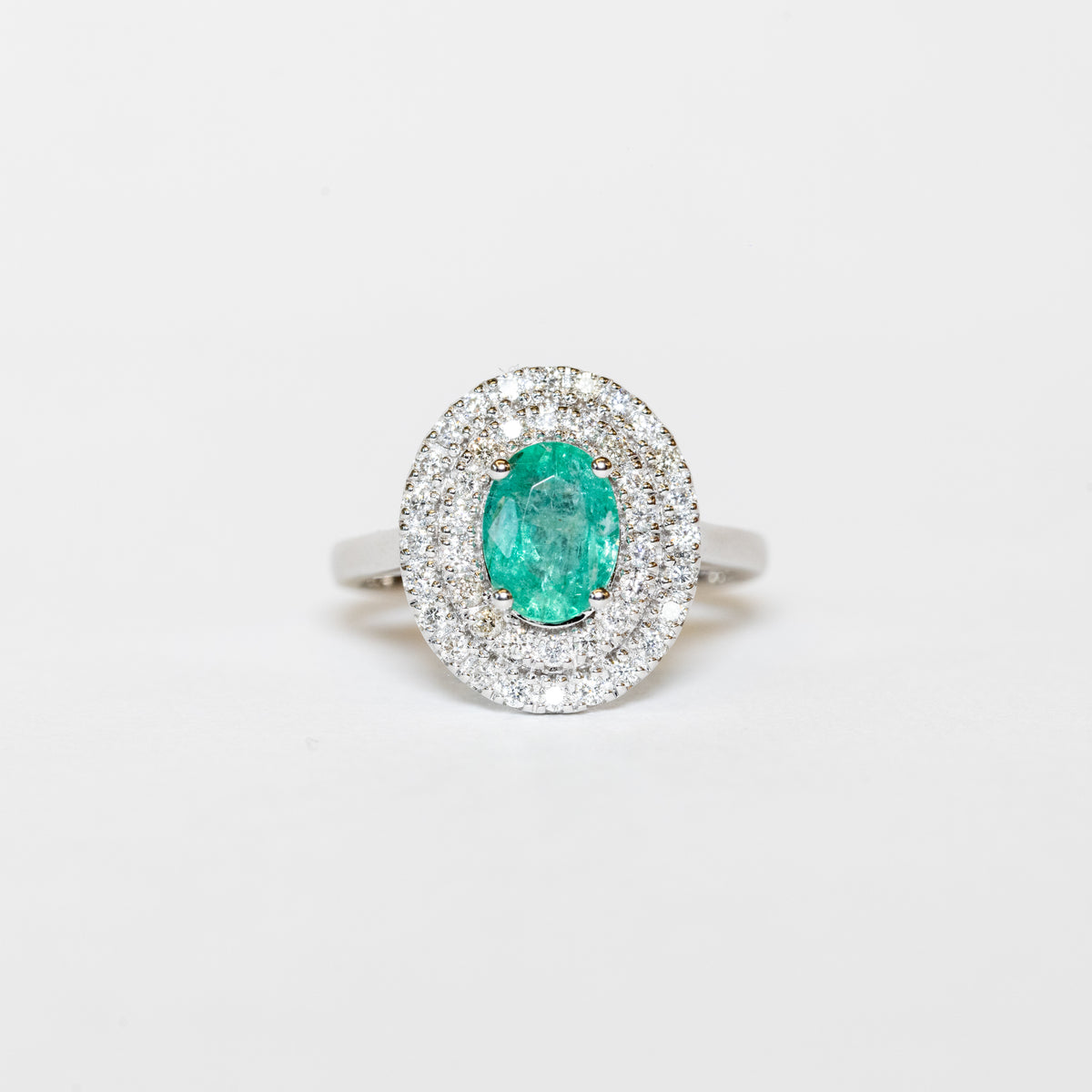 18Kt White Gold Ring With Oval Emerald And Double Row Of Diamonds