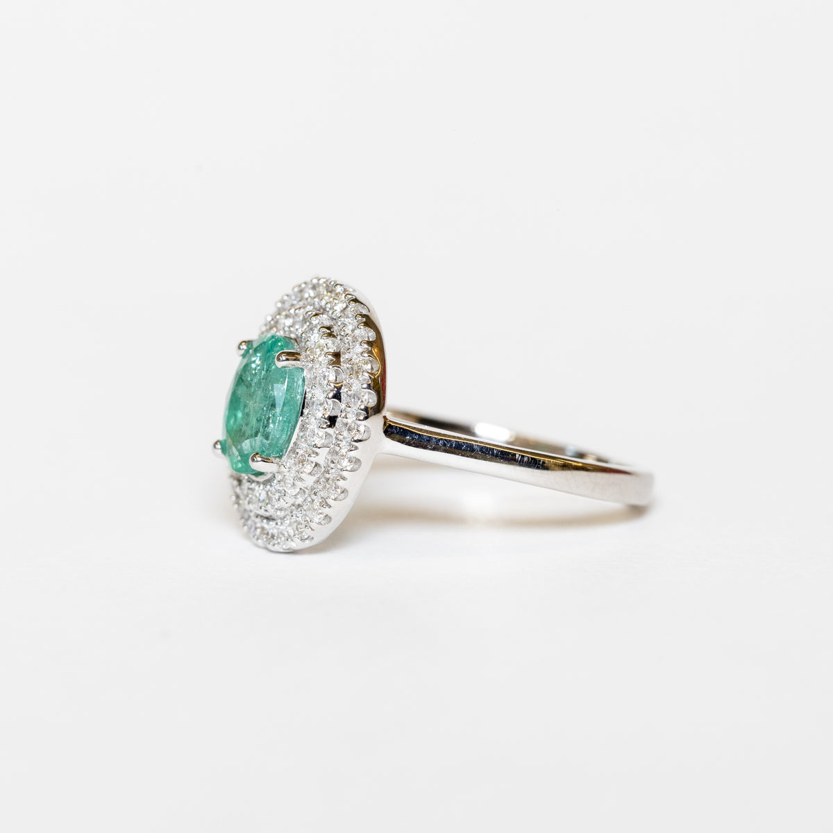 18Kt White Gold Ring With Oval Emerald And Double Row Of Diamonds