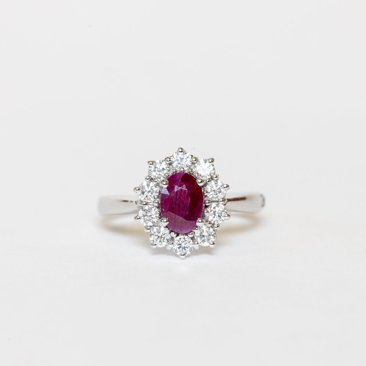 18kt White Gold Ring with Oval Shape Ruby and Diamond Surround