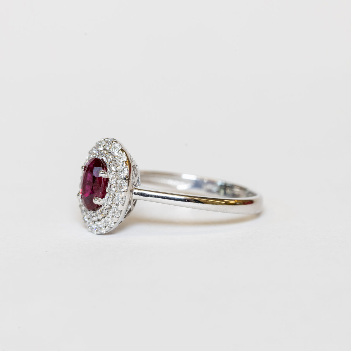 18KT White Gold Ring with Oval-Shaped Ruby and Double Diamond Surround