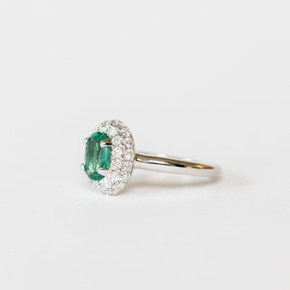18K White Gold Ring With Oval Emerald And Double Row Of Diamonds