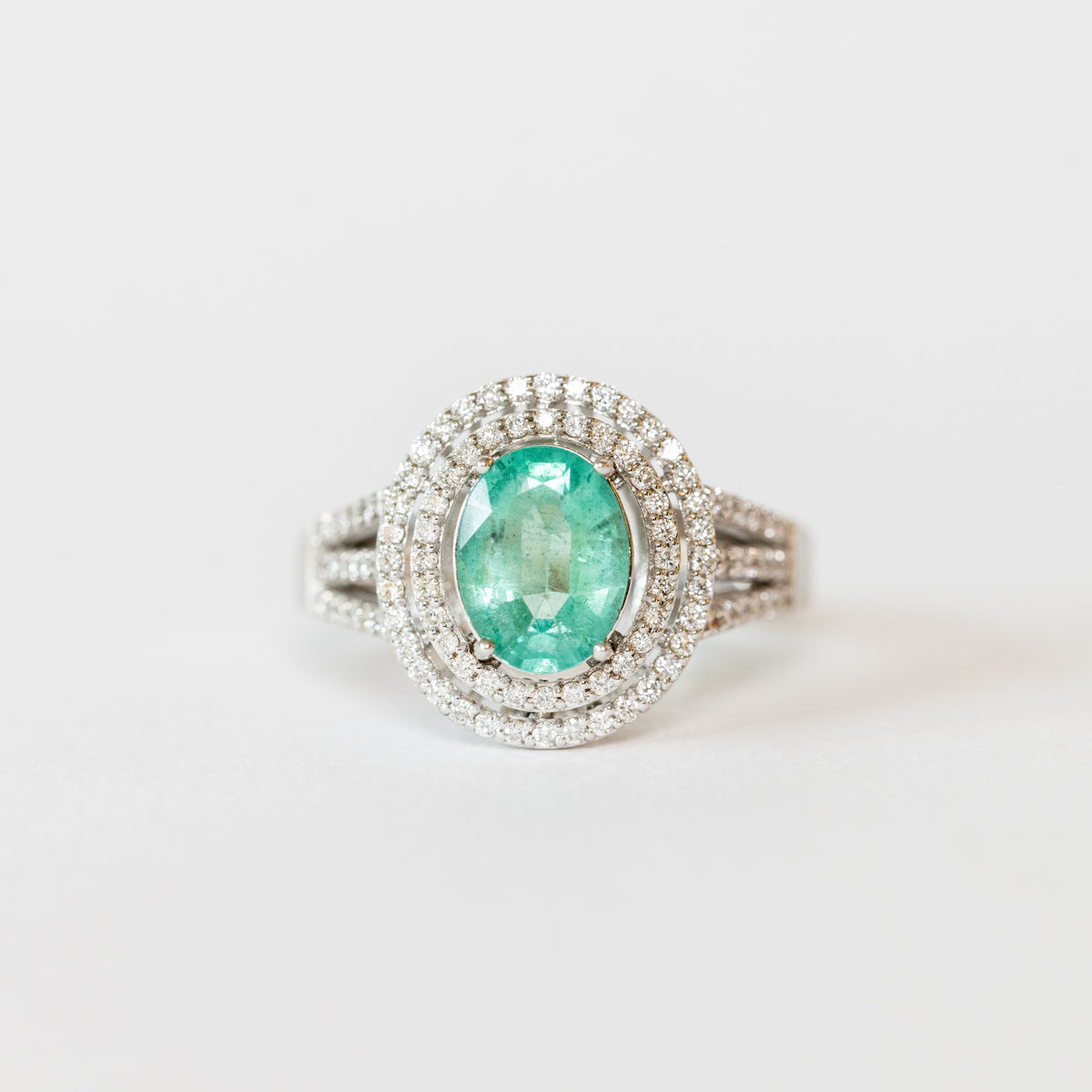 18 KT White Gold Ring with Emerald Oval Shape and Double Row of Diamonds