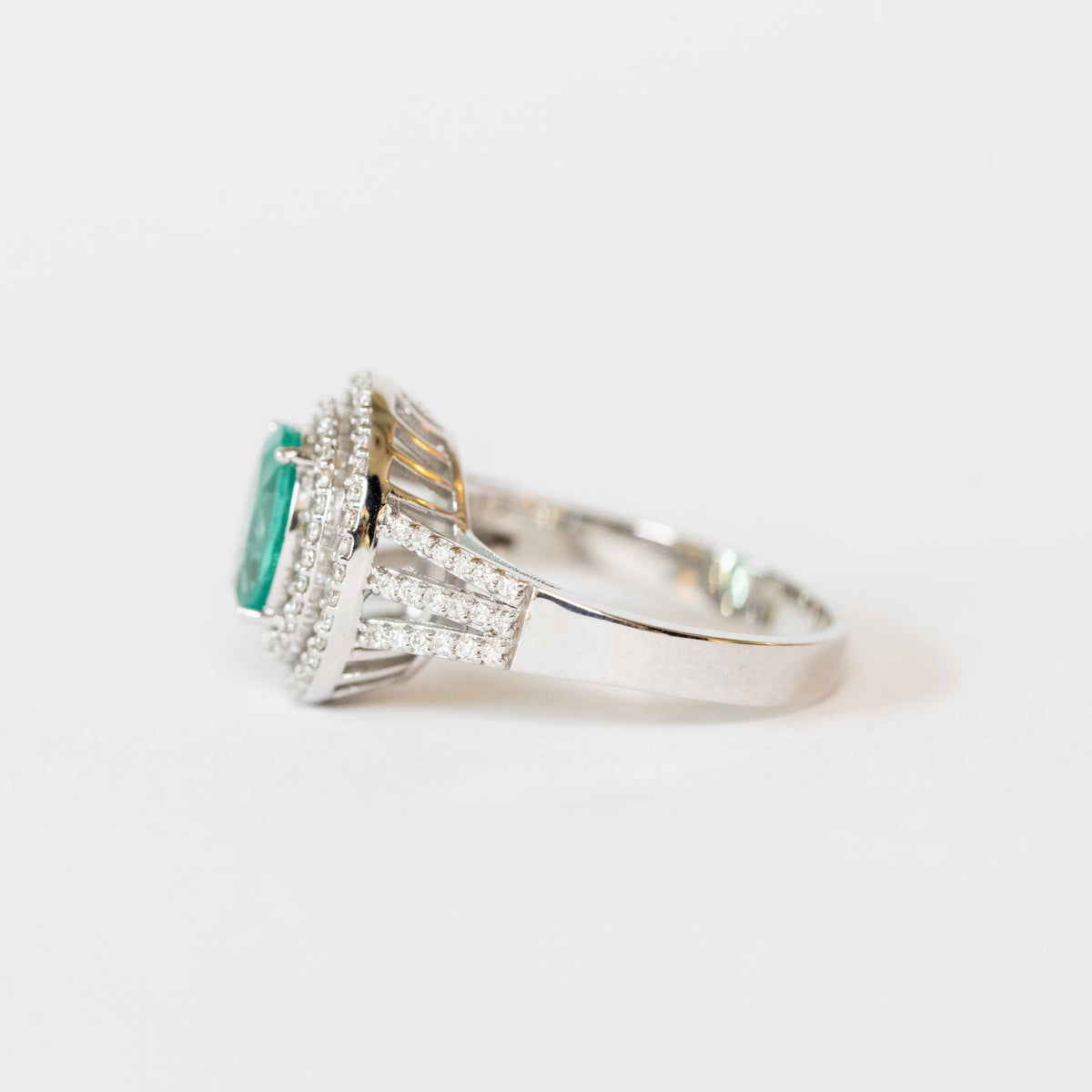 18 KT White Gold Ring with Emerald Oval Shape and Double Row of Diamonds