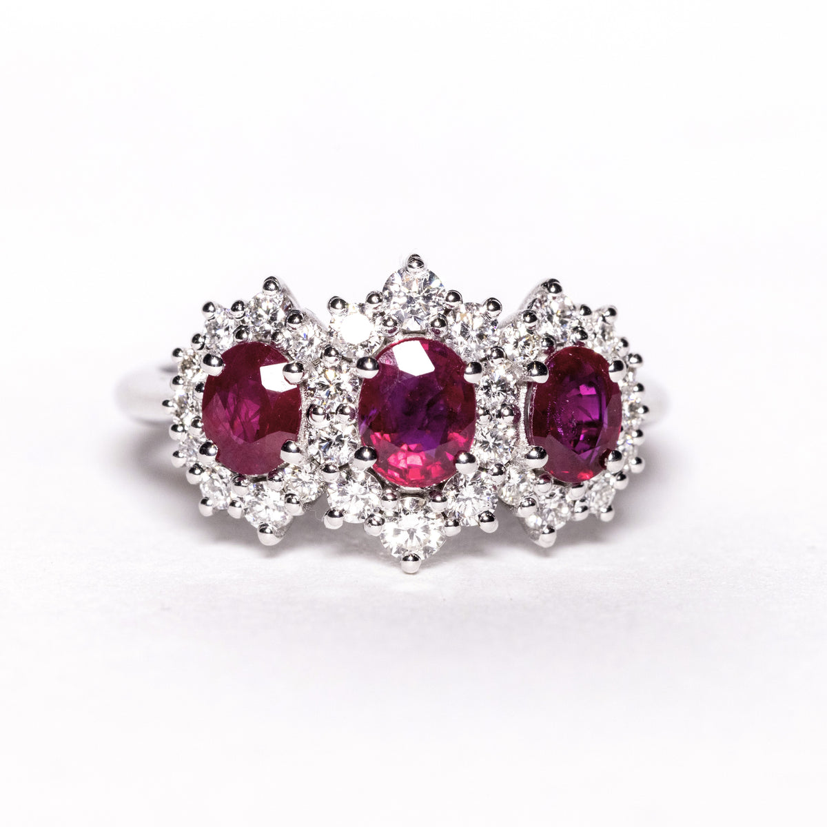 18kt White Gold Trilogy Ring with Rubies Surrounded by Diamonds