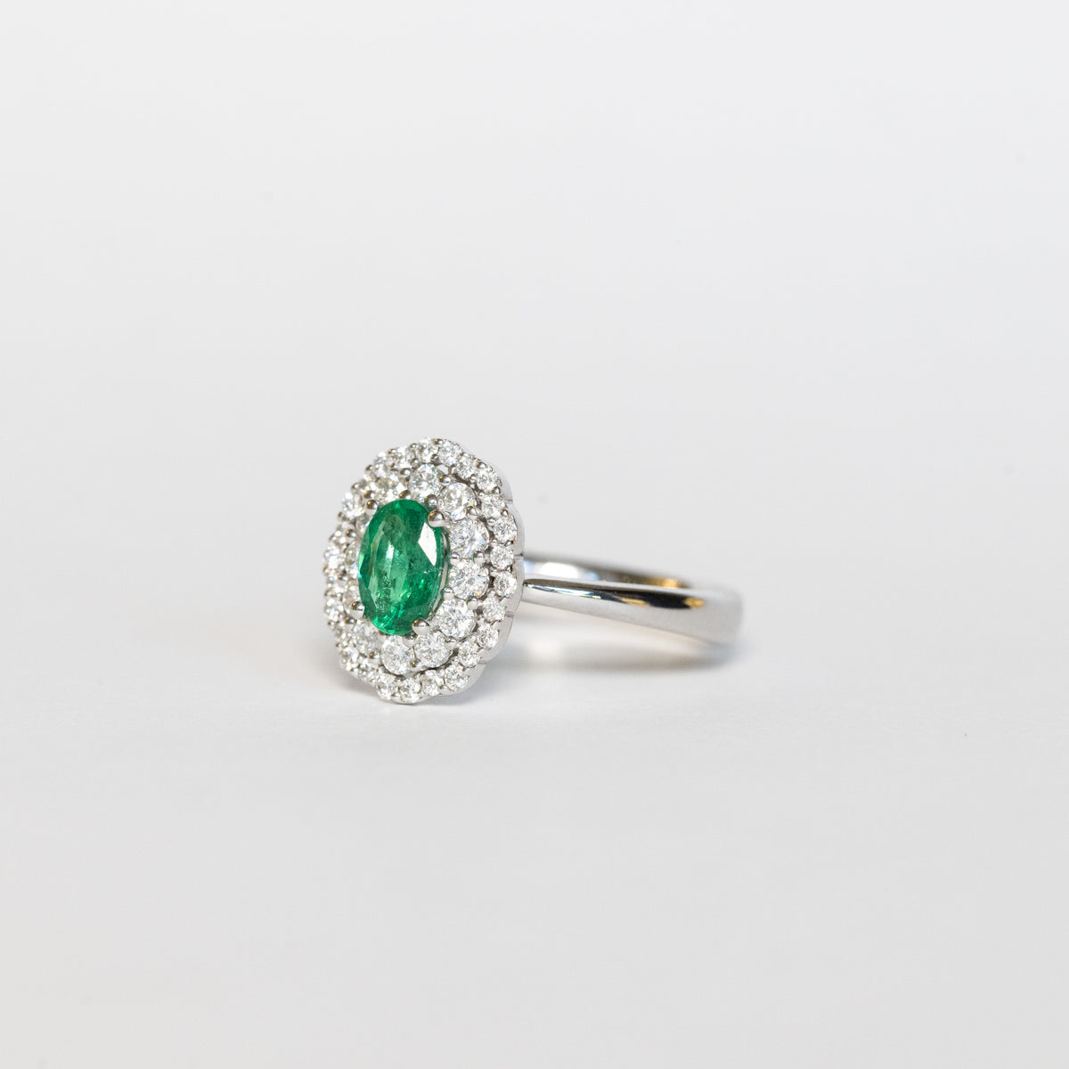 18kt White Gold Ring with Central Emerald and Double Row of Diamonds