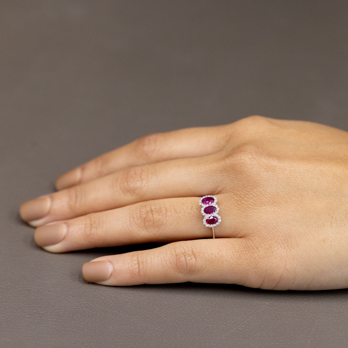 18Kt White Gold Trilogy Ring with Rubies Surrounded by Diamonds