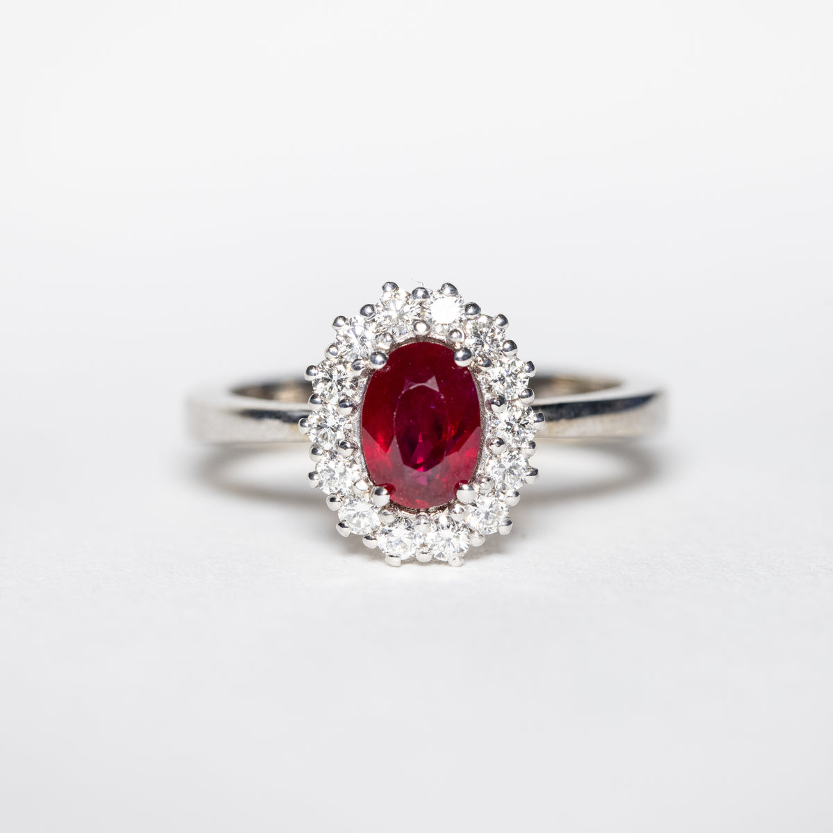 18kt White Gold Ring with Oval Ruby and Diamond Surround