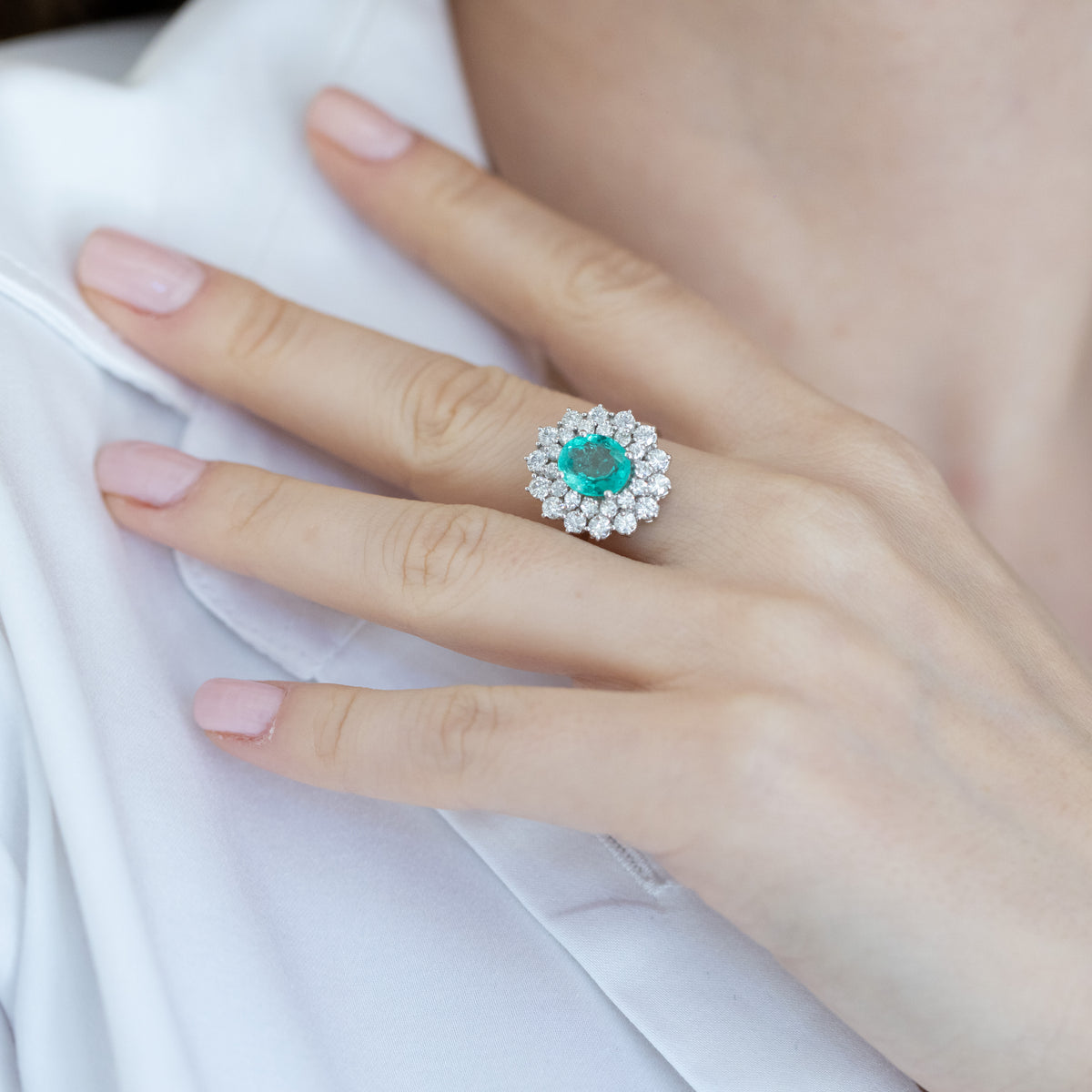 18KT White Gold Ring with Oval-Shaped Central Emerald and Double Diamond Surround