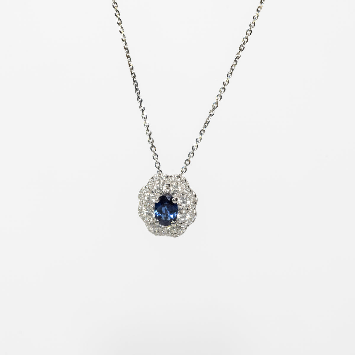 18kt white gold necklace with oval sapphire and double diamond contour