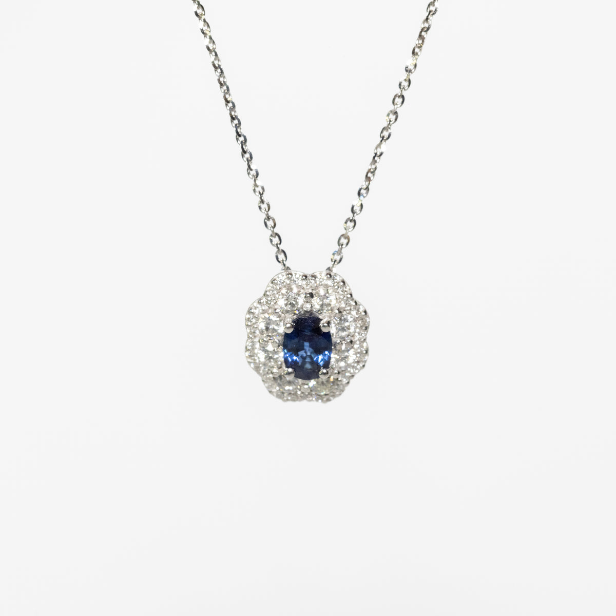 18kt white gold necklace with oval sapphire and double diamond contour