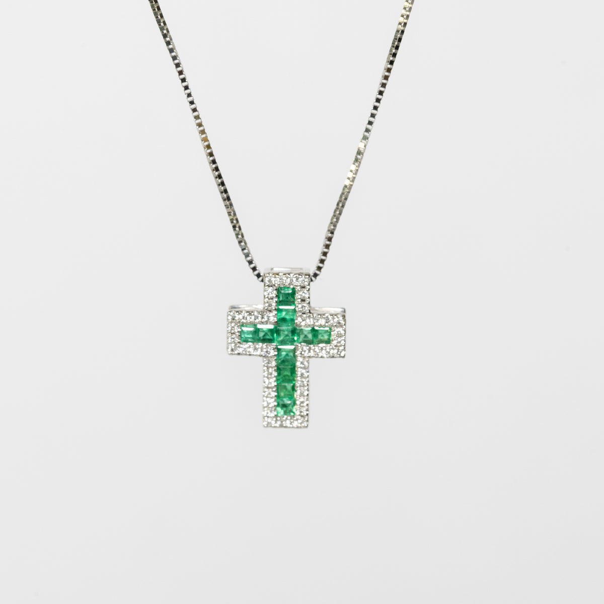 18kt white gold cross necklace with emeralds and diamonds