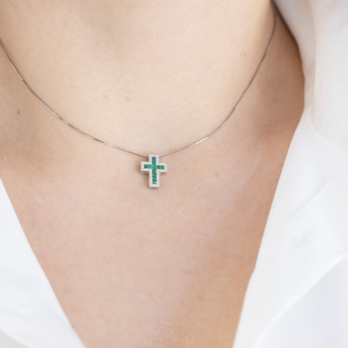 18kt white gold cross necklace with emeralds and diamonds