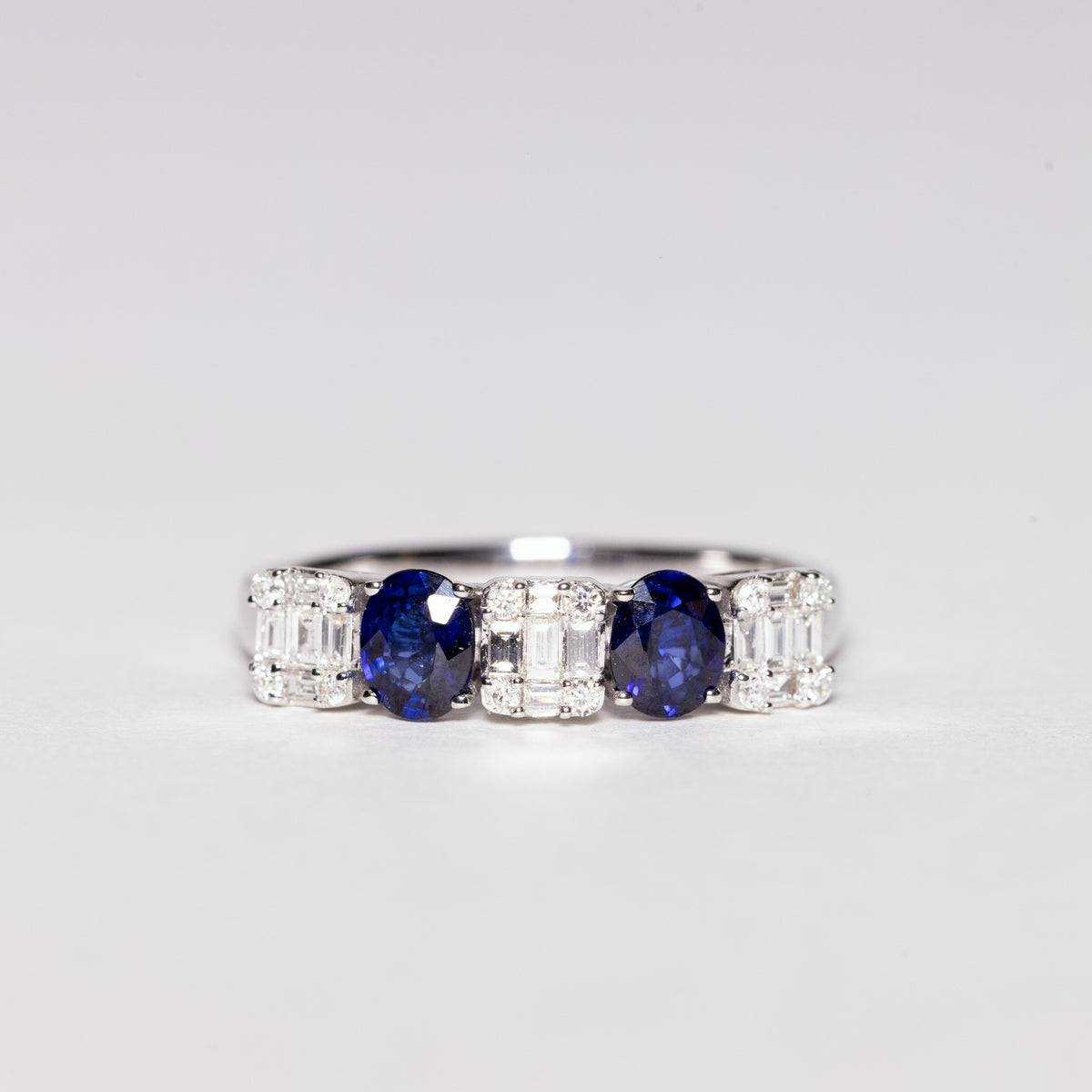 18kt White Gold Ring with Oval Cut Sapphires and Baguette Cut Diamonds