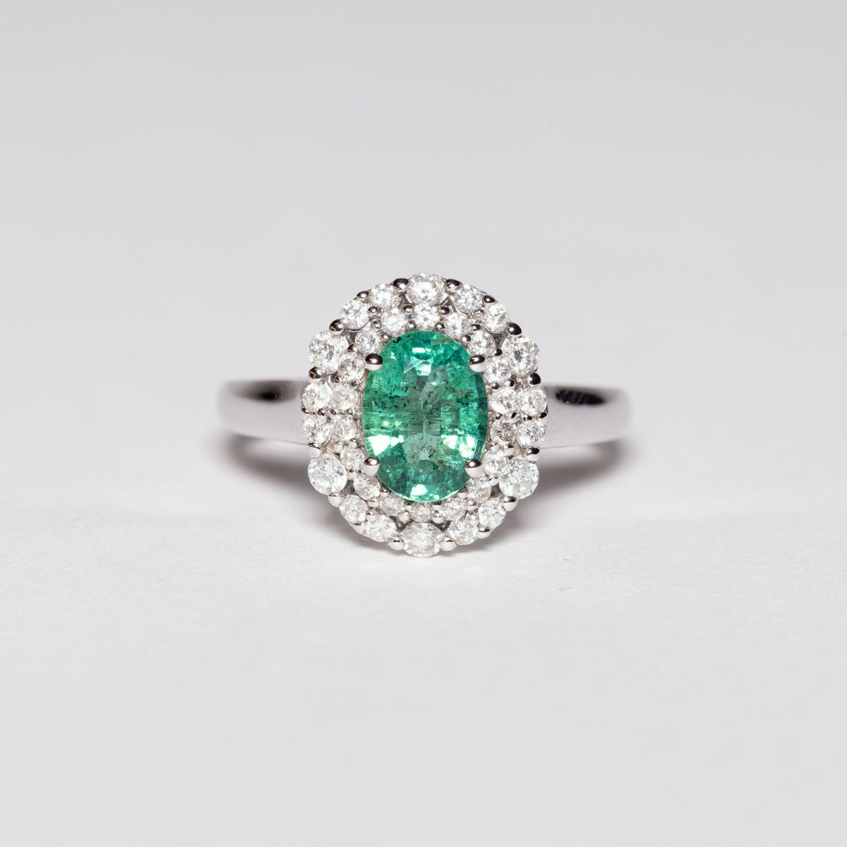 18 KT White Gold Ring With Central Emerald and Double Row of Diamonds