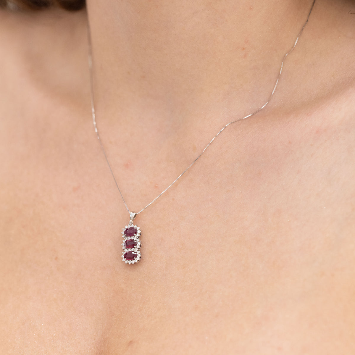 18K White Gold Necklace With Trilogy Of Rubies Surrounded By Diamonds