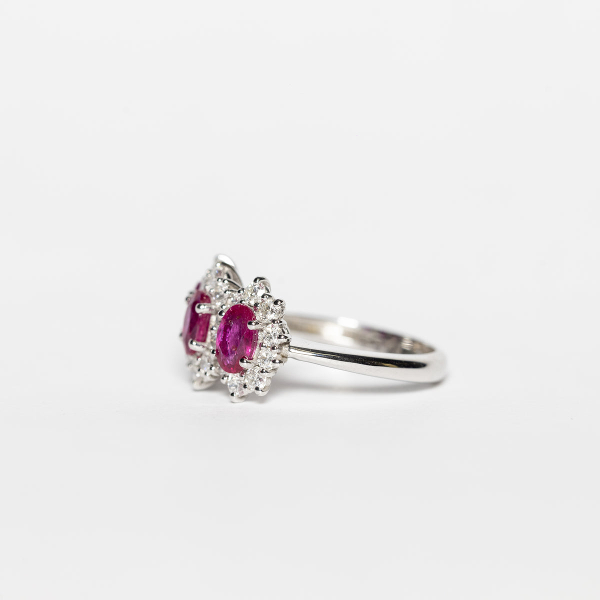 18kt White Gold Trilogy Ring With Rubies Surrounded By Diamonds