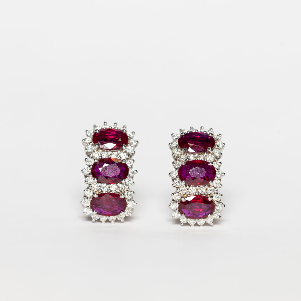 18K White Gold Trilogy Earrings With Rubies Surrounded By Diamonds