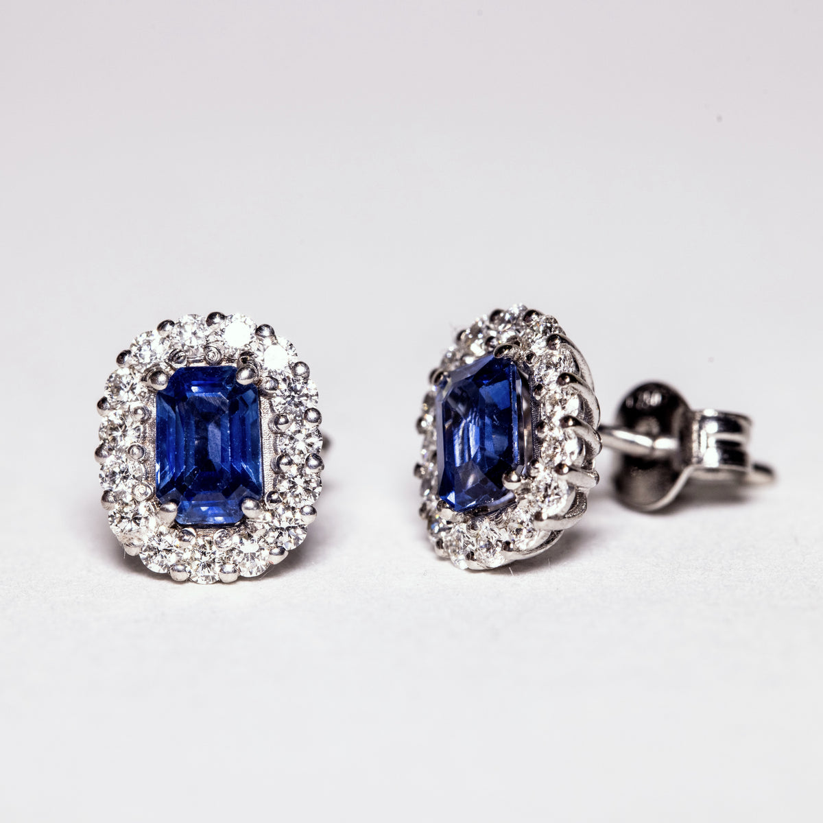 18kt white gold earrings with baguette cut sapphires and diamond surround