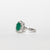 Anello in Oro Bianco 18KT con Smeraldo Ovale da 1,42kt contornato in diamanti da 1,15kt