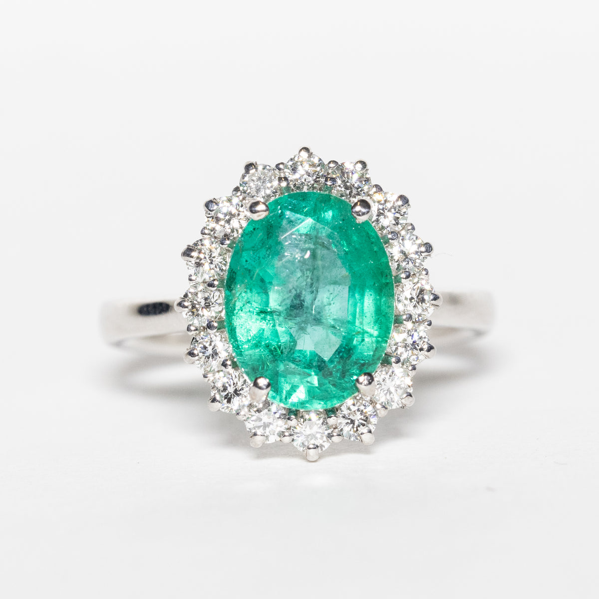 18KT White Gold Ring with 2.11 ct Oval Emerald and Diamond Surround 