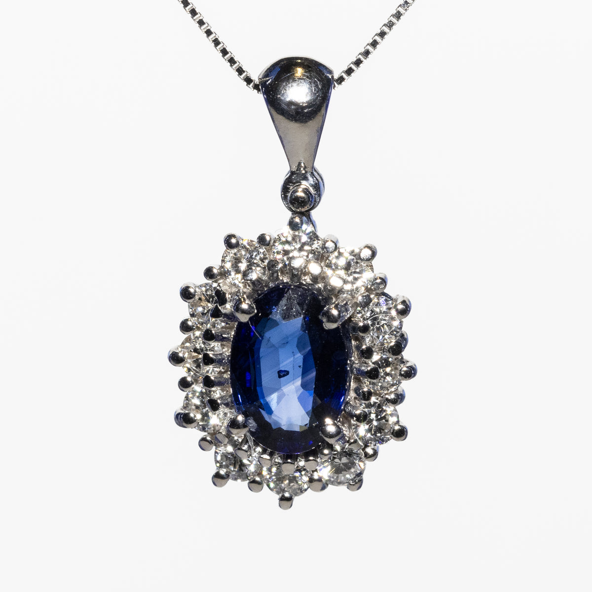 18KT White Gold Pendant Necklace with Oval Sapphire and Diamond Surround