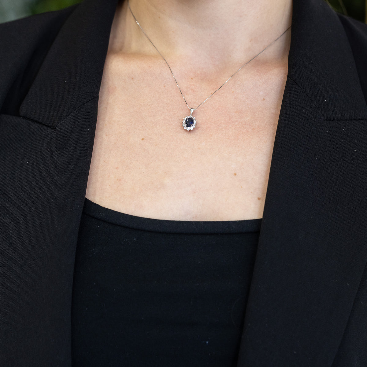 18KT White Gold Pendant Necklace with Oval Sapphire and Diamond Surround