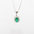 18kt white gold necklace with central emerald and diamond surround