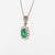 18kt white gold necklace with central emerald and diamond surround