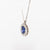 18kt white gold necklace with central sapphire and diamond surround