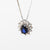 18kt white gold necklace with central sapphire and diamond surround