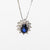 18kt white gold necklace with central sapphire and diamond surround