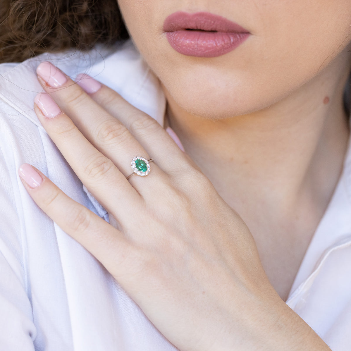 Anello in oro bianco 18 kt con smeraldo centrale con giro di diamanti