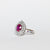Anello in Oro Bianco 18 kt con Rubino centrale e doppio giro di Diamanti