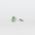 Anello in oro bianco 18 kt con smeraldo centrale con giro di diamanti