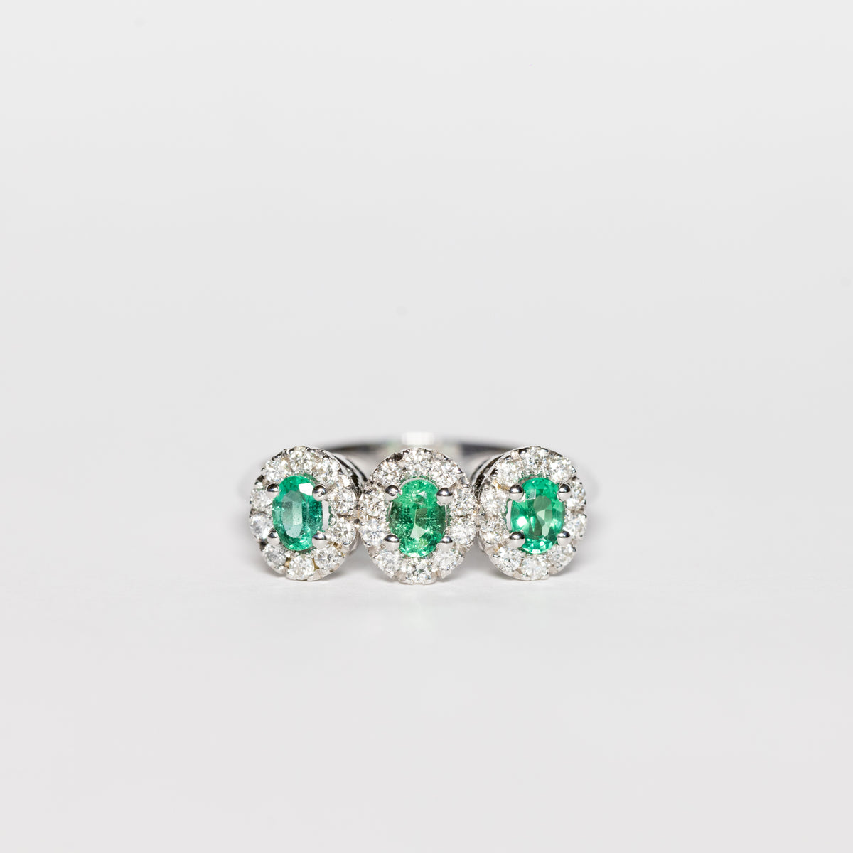 18K White Gold Trilogy Ring With Emeralds Surrounded by Diamonds