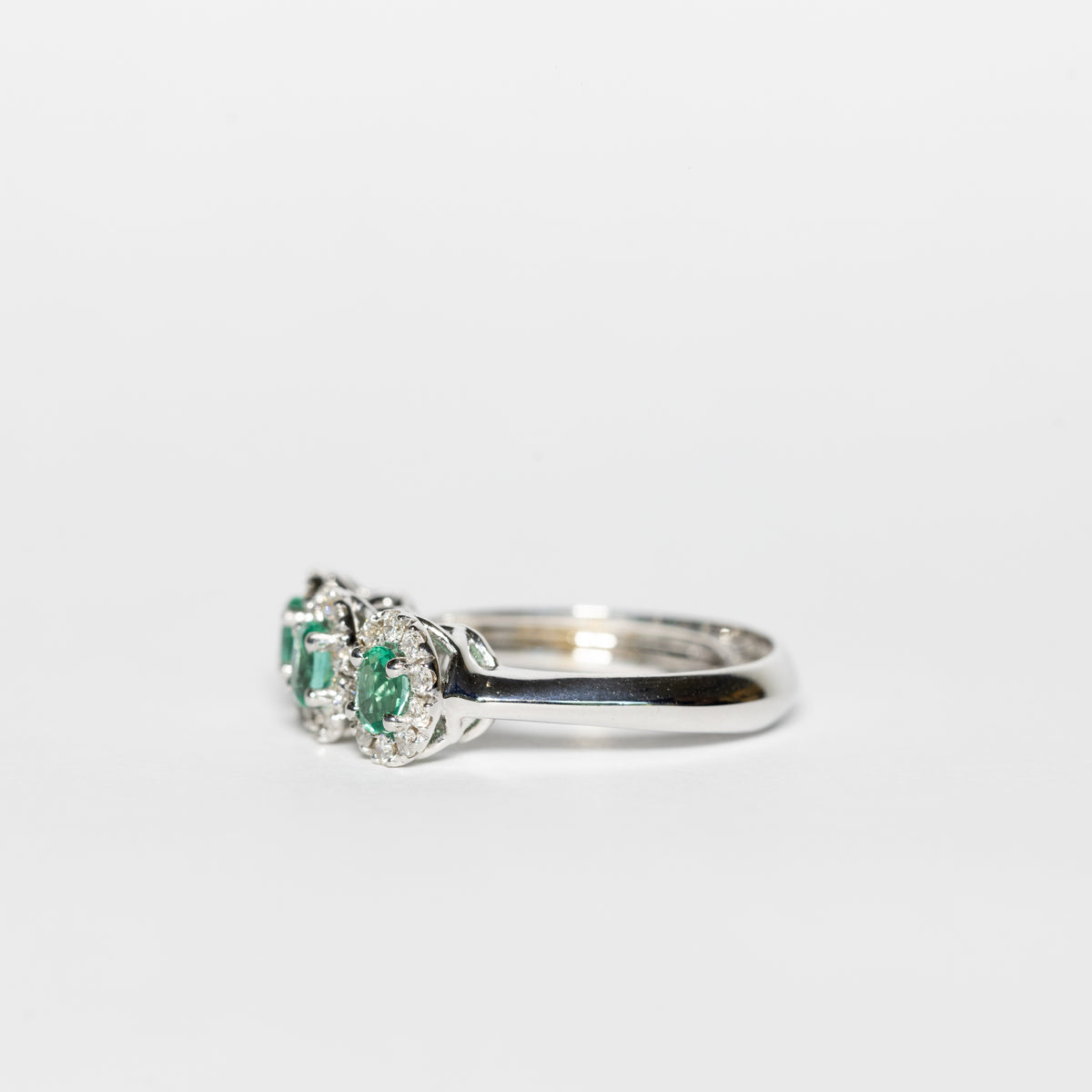18K White Gold Trilogy Ring With Emeralds Surrounded by Diamonds