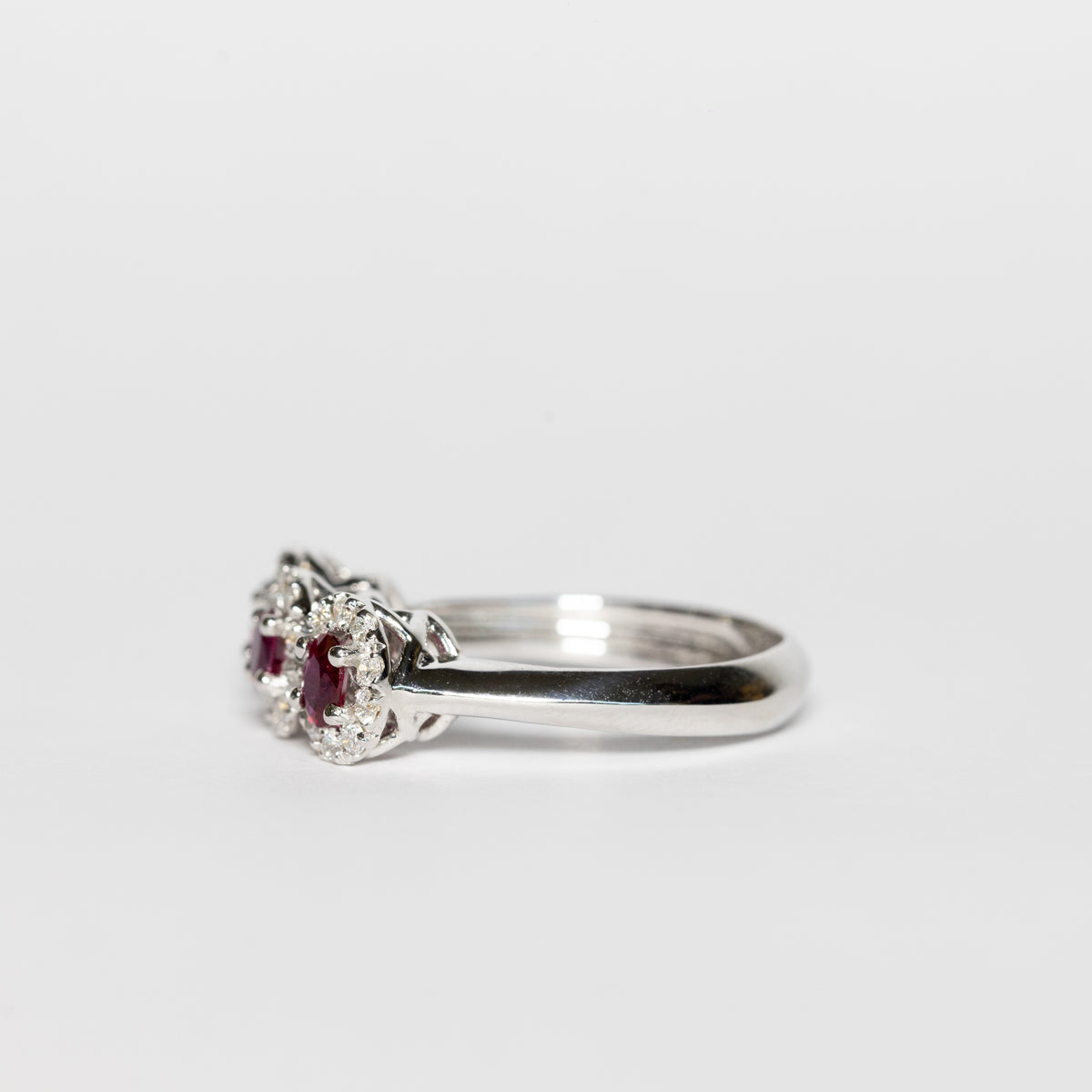 18K White Gold Trilogy Ring With Rubies Surrounded by Diamonds