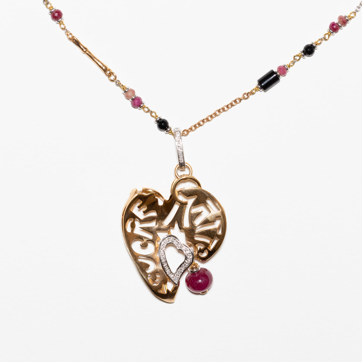 "Cuore Matto" necklace in 18 kt yellow gold with Onyx, ruby ​​root and diamonds