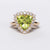 Anello in oro giallo 18 kt con Peridoto contornato di diamanti