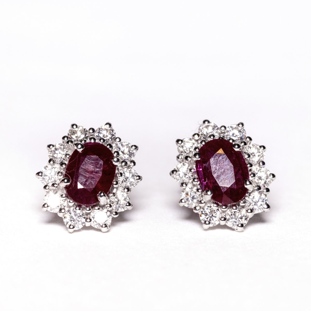 18kt white gold earrings with rubies surrounded by diamonds
