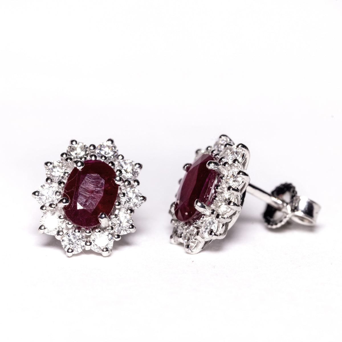 18kt white gold earrings with rubies surrounded by diamonds