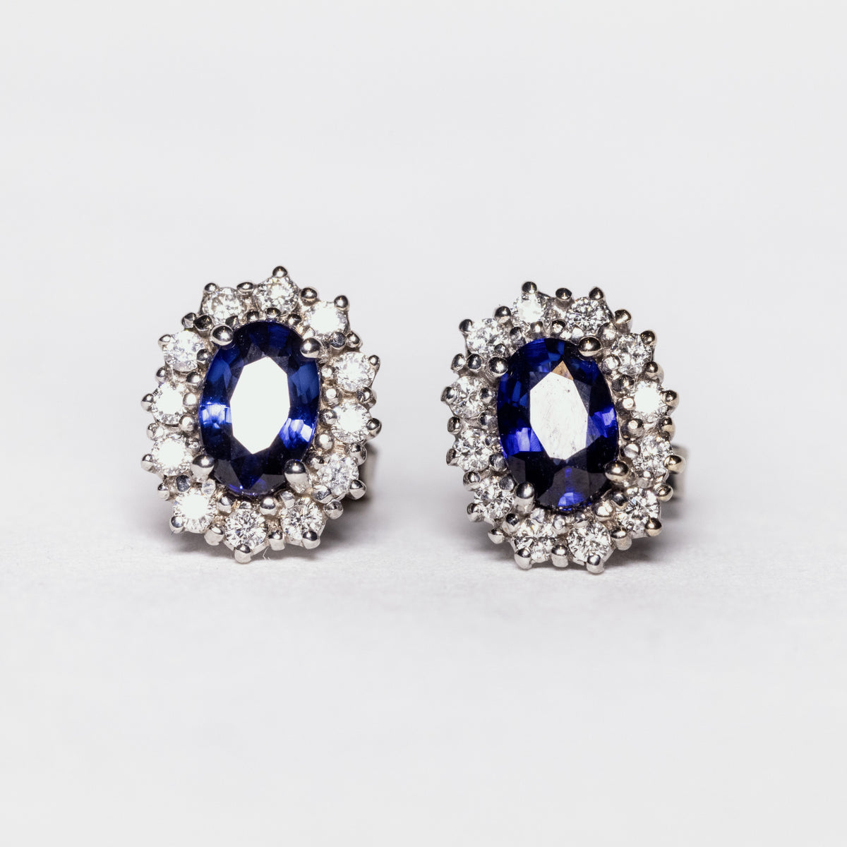 18kt white gold earrings with sapphires surrounded by diamonds