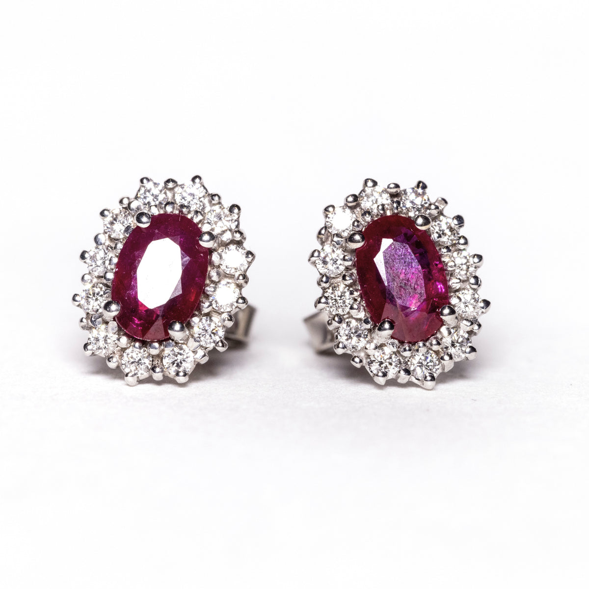 18kt white gold earrings with rubies surrounded by diamonds