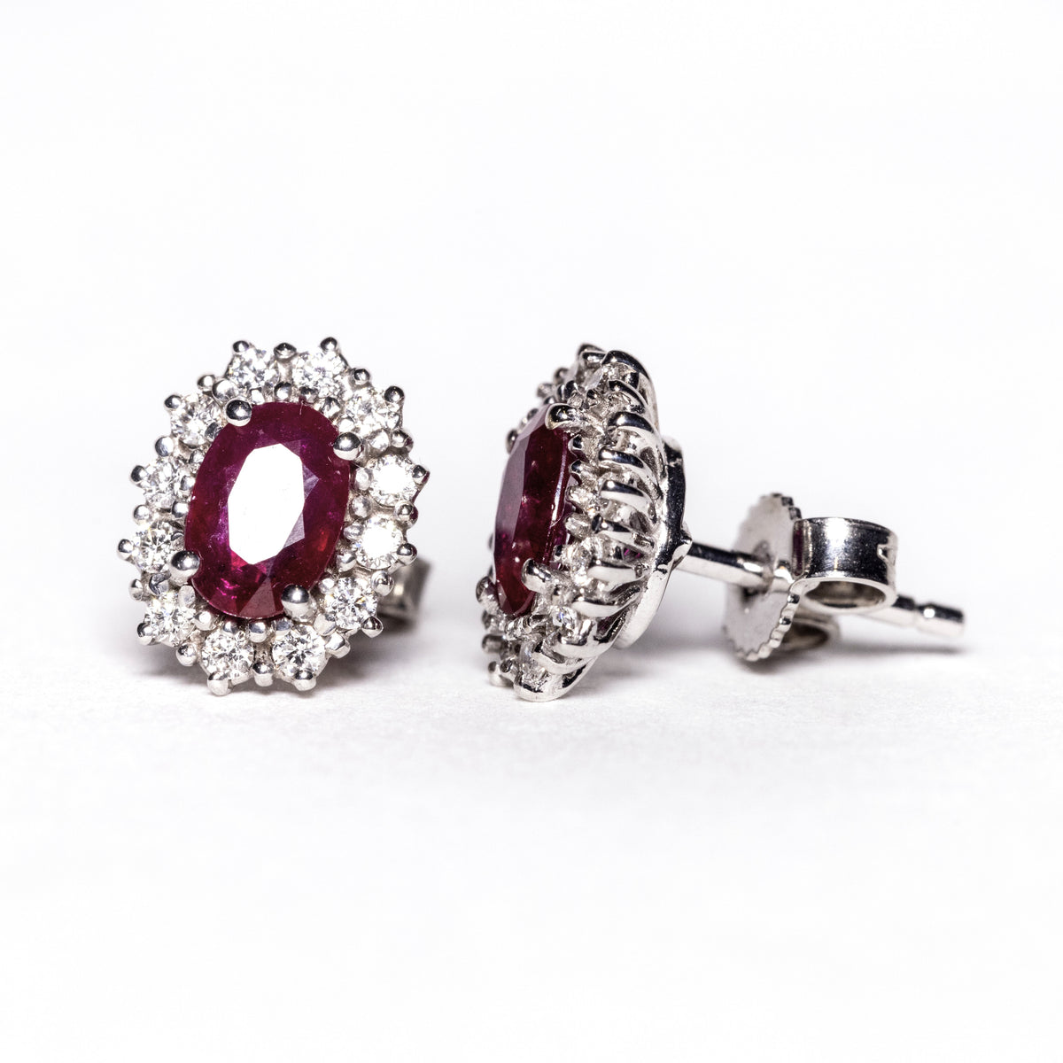 18kt white gold earrings with rubies surrounded by diamonds