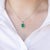Collana in oro bianco 18 kt con smeraldo ovale e contorno di diamanti
